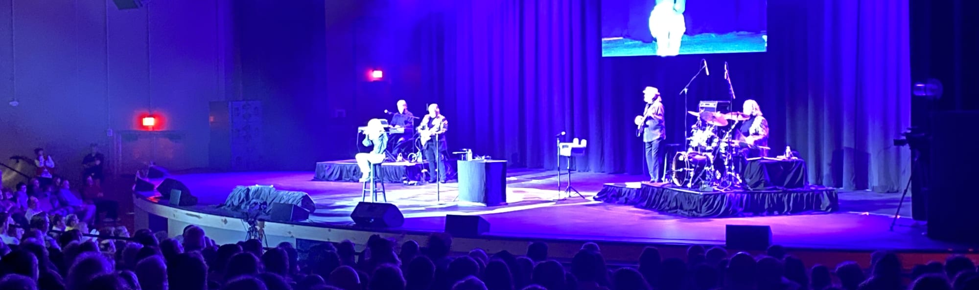 signer on stage in chair washed out by the lights Corpus Christi